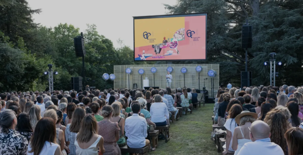 people attending outdoor event with stage